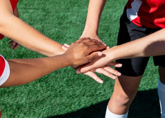 close-up-team-players-holding-hands